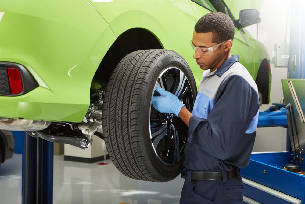 Honda service technician rotating tires