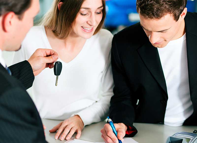 couple getting keys from salesman